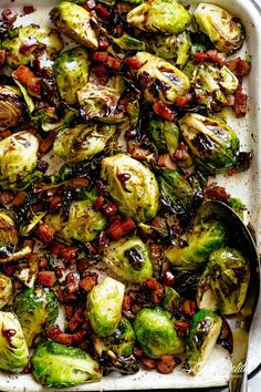 brussel sprouts with bacon and sun dried tomatoes in a white casserole dish