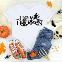 a t - shirt with the words happy halloween on it next to some pumpkins