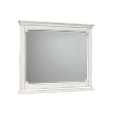 a white framed mirror sitting on top of a wall