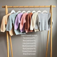 a rack with sweaters hanging from it's hooks