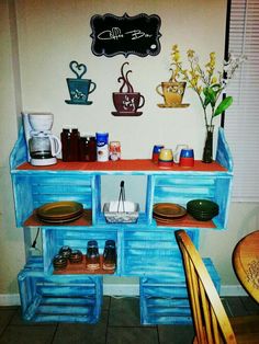 there is a blue shelf with cups and plates on it