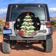 a christmas tree on the back of a jeep with snowflakes and presents around it