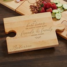 two wooden cutting boards with engraved names and vegetables on them, one has a puzzle piece