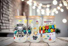 three insulated cups with the words best dad ever and video game controllers on them