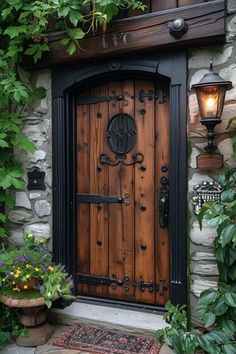 a wooden door in front of a stone building with ivy growing on it's sides