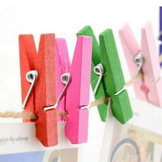 colorful clothes pins are hanging on a rope