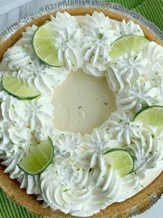 a pie with limes and whipped cream on top