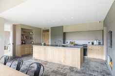 an open kitchen and dining area with wooden cabinets