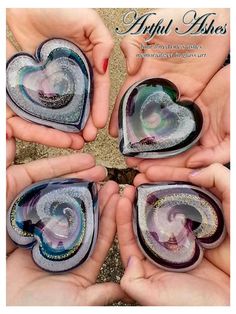 four hands holding heart shaped glass pieces in the shape of a spiral, on top of each other