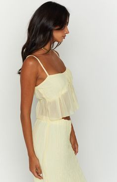 * Yellow Cami Top  
 * Major summer vibes! Pair this cute cami crop top () with the matching maxi skirt (), or with shorts () for a more relaxed look.  
 * 
 
 * Cropped style  
 * Adjustable spaghetti straps  
 * Flowy style 
 * Lined bust 
 * Sheer below bust 
 * Light weight material 
 * Sleeveless Flowy Style, Prom Midi Dress, Tank Crop Top, 60's Dress, Vest Crop Top, Summer Playsuit, Women Y2k, Strapless Tops, Crop Top Sweater