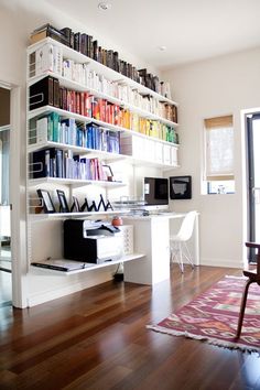 a room with bookshelves filled with lots of books