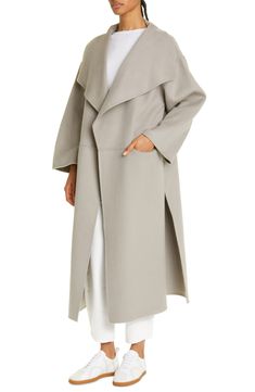 This stunningly minimal coat kissed with cozy cashmere features an easy, wear-with-everything design that you'll be reaching for in the years to come. 49 1/2" length (size Medium) Open front Drape lapels Front drop-in pockets Unlined 90% wool, 10% cashmere Dry clean Imported SPACE: A shop for emerging and advanced designers Elegant Outerwear With Shawl Collar For Daywear, Elegant Shawl Collar Outerwear For Daywear, Spring Wool Coat With Lapel Collar And Concealed Placket, Minimal Coat, Cashmere Coat, Wool Coat, Front Open, Duster Coat, Cashmere