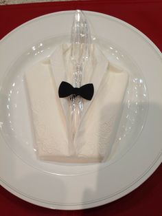 a white plate topped with a black bow tie