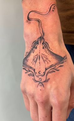 a man's hand with a tattoo on it