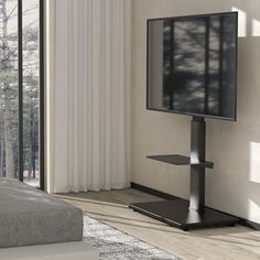 a flat screen tv sitting on top of a stand in a living room next to a window