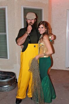 a man and woman dressed up in costumes posing for the camera while standing next to each other