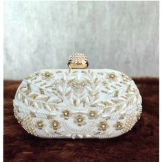 This stunning Party Clutch Bag is embellished with Zardozi work on a white silk Base . This Minaudière Clutch is ideal for parties and weddings and any festive occasion. This Handmade Embroidered Embellished Sling Purse can be used with or without the metal sling that is included. Dazzle through the Day or Evening with this beautifully Handcrafted Wedding Bridal Clutch Bag. Perfect for a Bride, Bridal Gift, Bridal Clutch, Wedding Clutch, Mehndi, Nikaah, Shaadi, Sangeet, Indian and Pakistani even Engagement Gift Boxes, Bridal Clutch Bag, Handmade Wedding Gifts, Bridal Handbags, Bridal Bag, Potli Bags, Party Clutch, Wedding Clutch, Bridal Clutch