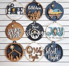 twelve christmas ornament ornaments with the names of different nativitys on them