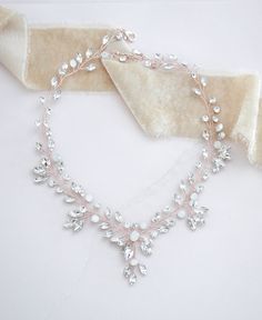 One of our best selling designs, our rose gold necklace is hand wired with white opal and clear crystals in a cascading vine style. - Created with premium white opal and clear crystals - Available in rose gold, light gold, and silver. - Necklace measures 14 inches and extends to 16 inches - Nickel free and hypoallergenic Matching pieces: https://www.etsy.com/listing/765074596/crystal-bridal-earrings-bridal-jewelry?click_key=c8b6bc0006bddbfd50f327fc8c2cb4ee4be9bed4%3A765074596&click_sum=fbcf883e& Rose Gold Wire Wrapped Jewelry For Party, Elegant Rose Gold Crystal Necklace For Wedding, Delicate Wire Wrapped Wedding Jewelry, Delicate Wire Wrapped Jewelry For Wedding, Delicate Wire Wrapped Necklace For Wedding, Delicate Wire Wrapped Necklaces For Weddings, Rose Gold Crystal Necklaces For Wedding, Elegant Crystal Necklace With Wire Wrapped Detail, Adjustable Wire Wrapped Necklace For Wedding