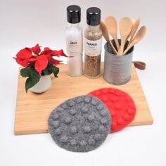 a wooden cutting board topped with spices and utensils