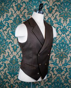 "ABOUT THIS STYLE: The style features a 1930s style jacket with a low gorge and a ticket pocket, a double-breasted notch collar vest, and a high-waisted pant with an extended waistband tab. With all of our designs, we look backward across the great history of menswear and try to bring forward is best and most fresh from the past, discarding what does not speak to our present age, but retaining all of the traditional craftsmanship and quaility. The suit is made from a vintage style herringbone su Fitted Double Breasted Suit With Notch Lapel, Fitted Brown Double Breasted Suit With Notch Lapel, Brown Fitted Double Breasted Suit With Notch Lapel, Fitted Brown Double Breasted Suit With Welt Pockets, Fitted Brown Double Breasted Suit For Fall, Dapper Double Breasted Suit With Notch Lapel, Fitted Three-piece Suit With Lapel Collar For Fall, Fitted Three-piece Suit With Lapel Collar And Double Button, Fitted Double-breasted Three-piece Suit With Button Closure