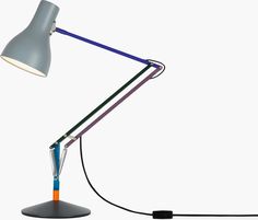 a desk lamp that is on top of a white surface with a cord attached to it