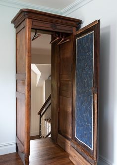 an open wooden door in the middle of a room