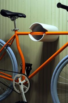 an orange bike with a cup holder attached to it