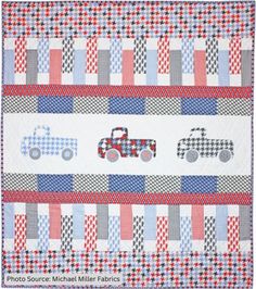 a quilted wall hanging with three trucks on the front and one truck on the back