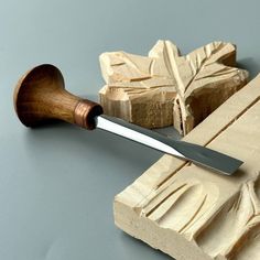 a wooden object with a knife on top of it