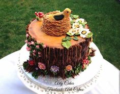 a cake decorated with flowers and birds nest