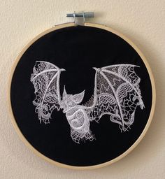 an embroidered bat hanging on the wall