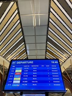 an airport departure board is shown in the terminal's check - in line area