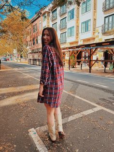 a woman standing in the middle of an empty street