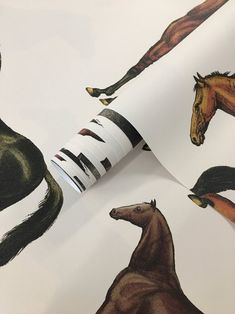 the wallpaper has horses on it and is white with black stripes, as well as brown