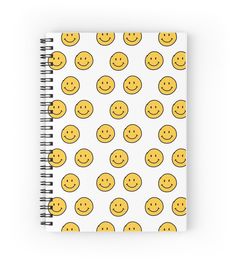 a spiral notebook with yellow smiley faces on it