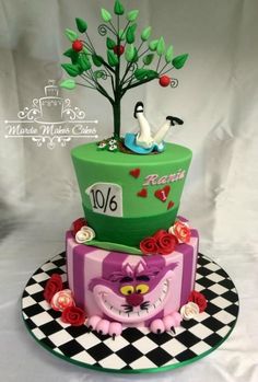 a three tiered cake decorated with an image of a cat and bird on top