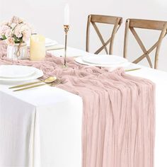 the table is set with plates, silverware and pink linens for an elegant look