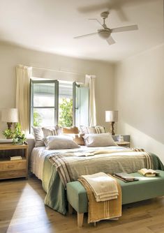 a bedroom with a bed, dresser and window in it's centerpieces