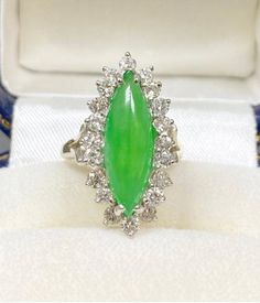 "Pacific Jewelry Presents, 20 Scintillating VS clarity diamonds centering a high quality Marquise shaped Jade. This ring centers a 3 carat Jade Gemstone with oriental origins. As the Chinese saying goes, \"Gold is valuable, but Jade is priceless\", no gemstone in history holds the metaphysical and religious significance as Jade, particularly in Chinese and Mayan/Aztec cultures. ✔ Gold Karat: 14K White Gold ✔ Jade Weight: Approximately 3 carats ✔ Jade Origin: Burma ✔ 3rd party Certificatory/Appra Heirloom Green Jade Rings, Luxury Jade Ring Jewelry, Luxury Green Jade Rings, Carved Green Jade Rings, Hand-strung Green Jade Jewelry, Green Gemstone Ring, Aztec Culture, Chinese Jade, Jade Ring