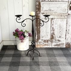 a potted plant sitting on top of a metal stand next to a white door