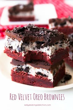 three red velvet dessert bars stacked on top of each other with white and chocolate toppings