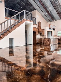 an empty room with shiny floors and wooden railings on the second floor is shown