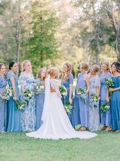 a bride and her bridal party in blue dresses