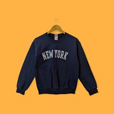 New York city spell out sweatshirt New York city crewneck New York sweater pullover streetwear sports style dark blue colour size small by YoungmodernCo on Etsy Navy Crew Neck Sweatshirt With Logo Print, Navy Crew Neck Sweatshirt With Logo, Navy Letter Print Sweater For Winter, Navy Graphic Print Sweatshirt For Fall, College Style Crew Sweater For Streetwear, College Style Crew Neck Sweater For Streetwear, Casual Crew Neck Sweater For Streetwear, Navy Long Sleeve Sweater For Streetwear, Navy Crew Neck Sweater With Letter Print