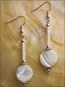 the earrings are white and have pearls on them