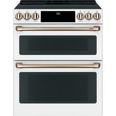 two white and gold ovens side by side