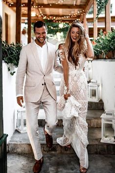 a man and woman are walking down the stairs