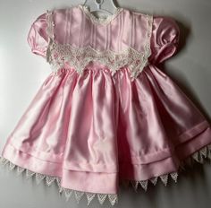 "Beautiful dress fully lined - Trimmed in a dainty white lace - full skirt with a large pre-made bow on back. Only issue a few tiny snags (as seen in last photo) -hardly noticeable - Labeled size 24 months measures pit to pit 9 1/2\"/ length (shoulder to bottom lace) 18\"/ Smoke free environment (122)" Cute Fitted Lace Baptism Dress, Fitted Princess Dress With Lace Trim, Pink Vintage Victorian Dress For Fancy Dress, Cute Baptism Dress With Lace Trim For Formal Occasion, Cute Baptism Dress With Lace Trim, Princess Dress For Dress-up With Lace Trim, Princess Dress With Lace Trim For Dress-up, Princess Style Dress With Lace Trim For Dress-up, Pink Princess Dress With Lace Trim For Dress-up