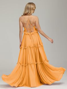 a woman in an orange dress is standing back to back